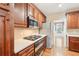 Well-lit kitchen features stainless steel appliances, wood cabinets, and eat-in breakfast nook at 2118 Township Dr, Woodstock, GA 30189