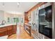 Modern kitchen features stainless steel appliances, wood cabinets, and wood flooring with a breakfast nook at 2118 Township Dr, Woodstock, GA 30189