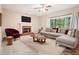 Cozy living room with fireplace, TV, large sofa, a patterned rug, and plenty of light from large windows at 2118 Township Dr, Woodstock, GA 30189