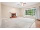 Inviting living room featuring a brick fireplace, a large window, neutral carpet, and recessed lighting at 2118 Township Dr, Woodstock, GA 30189