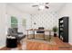Bright office featuring hardwood floors, neutral walls, area rug, and stylish desk with chair at 2118 Township Dr, Woodstock, GA 30189