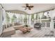 Relaxing sunroom with comfortable seating, curtains and fan at 2118 Township Dr, Woodstock, GA 30189