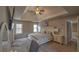 Primary bedroom with tray ceilings, large windows and carpeted floors at 2234 Oak Falls Ln, Buford, GA 30519