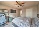 Bedroom features carpet, ceiling fan, and a desk with a large computer screen at 2234 Oak Falls Ln, Buford, GA 30519