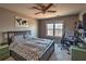 Bedroom features ceiling fan, carpet, desk, bed, and window overlooking mature trees at 2234 Oak Falls Ln, Buford, GA 30519