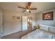 Inviting bedroom with neutral tones, ceiling fan, and easy access to the upstairs hallway at 2234 Oak Falls Ln, Buford, GA 30519