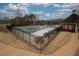 Community pool area with fencing, picnic tables, and lounge chairs for residents' enjoyment at 2234 Oak Falls Ln, Buford, GA 30519