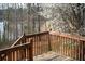Scenic wooden deck overlooking a serene lake surrounded by trees and blossoming flora at 2234 Oak Falls Ln, Buford, GA 30519