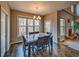 Cozy dining area adjacent to the living room with natural light and hardwood flooring at 2234 Oak Falls Ln, Buford, GA 30519