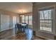 Bright dining room featuring hardwood floors, a modern chandelier, and scenic views from large windows at 2234 Oak Falls Ln, Buford, GA 30519