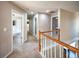 Upstairs hallway featuring neutral colored walls, carpeted floors and access to other rooms in the home at 2234 Oak Falls Ln, Buford, GA 30519