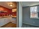 Basement kitchenette with white cabinetry and a window to the outdoors at 2234 Oak Falls Ln, Buford, GA 30519