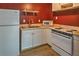 Basement kitchenette featuring a white refrigerator, oven, and double sink at 2234 Oak Falls Ln, Buford, GA 30519