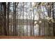 Picturesque view of a calm lake surrounded by trees, providing a tranquil natural setting at 2234 Oak Falls Ln, Buford, GA 30519