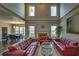 Bright living room with high ceilings, fireplace, large windows, and open access to the dining area at 2234 Oak Falls Ln, Buford, GA 30519
