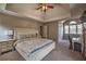 Spacious primary bedroom featuring a tray ceiling, large windows and carpeted floors at 2234 Oak Falls Ln, Buford, GA 30519
