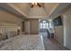 Bright main bedroom features a tray ceiling, sitting area, and large windows providing natural light at 2234 Oak Falls Ln, Buford, GA 30519