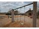 Community playground with swings, slides, and a soft ground cover, offering a safe play area at 2234 Oak Falls Ln, Buford, GA 30519