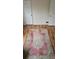 View of a bedroom featuring a decorative rug, two white doors, and laminate flooring at 3715 Millers Pond Way, Snellville, GA 30039