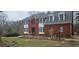 Traditional brick home featuring white trim, bay windows, dormers and a well-manicured lawn at 3715 Millers Pond Way, Snellville, GA 30039