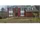 Charming two-story brick home featuring bright white trim and black accents, set against a natural landscape at 3715 Millers Pond Way, Snellville, GA 30039
