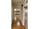 Hallway view with hardwood floors leading to the kitchen, accented by decorative doorway beads at 3715 Millers Pond Way, Snellville, GA 30039