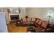 View of a living room with a brick fireplace and leather sectional sofa at 3715 Millers Pond Way, Snellville, GA 30039