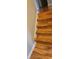 View of wooden stairs with wooden laminate and white trim at 3715 Millers Pond Way, Snellville, GA 30039