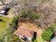 This is an aerial view of a cozy home with trees behind it and an unkempt yard that will be wonderful after a spring cleaning at 3844 Rena Se Ln, Smyrna, GA 30082