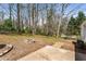 View of backyard with a brick firepit and wooded landscape at 3844 Rena Se Ln, Smyrna, GA 30082