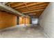 Unfinished basement with concrete floor, exposed wood ceiling and partition wall at 3844 Rena Se Ln, Smyrna, GA 30082