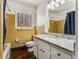 Tiled bathroom with wooden floors, bathtub, toilet, vanity and a mirror at 3844 Rena Se Ln, Smyrna, GA 30082