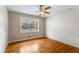 An empty bedroom features hardwood floors, paint walls, and natural light at 3844 Rena Se Ln, Smyrna, GA 30082