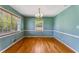 Cozy dining room with hardwood floors, large windows, and an elegant chandelier at 3844 Rena Se Ln, Smyrna, GA 30082