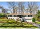 Charming white-painted brick home featuring black shutters and a well-maintained front yard at 3844 Rena Se Ln, Smyrna, GA 30082