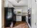 Traditional kitchen with white cabinetry, granite countertops and black appliances at 3844 Rena Se Ln, Smyrna, GA 30082