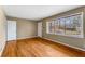 Sun-filled living room with hardwood flooring, freshly painted walls, and a large window at 3844 Rena Se Ln, Smyrna, GA 30082