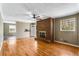 Comfortable living room with a brick fireplace, hardwood floors, and natural light streaming in at 3844 Rena Se Ln, Smyrna, GA 30082