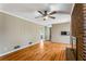 Inviting living room featuring a brick fireplace and gleaming hardwood floors at 3844 Rena Se Ln, Smyrna, GA 30082