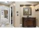 Elegant vanity area with a wood cabinet, decorative mirror, and access to closet space at 3858 Fenway Xing, Marietta, GA 30062