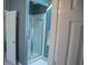 Enclosed glass shower with gold trim and blue striped wall paper in updated bathroom at 4288 Wyndham Park Cir, Decatur, GA 30034