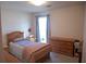 Cozy bedroom with full bed, wood dresser, and natural light from the window at 4288 Wyndham Park Cir, Decatur, GA 30034