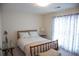 Inviting bedroom featuring neutral walls, a full bed with floral patterned linens, and natural light at 4288 Wyndham Park Cir, Decatur, GA 30034