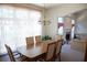 Bright dining room with a chandelier, large window, and seamless flow to the living space at 4288 Wyndham Park Cir, Decatur, GA 30034