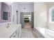 Bright bathroom featuring a soaking tub, white vanity, and tiled floors at 515 Quinn Dr, Woodstock, GA 30188