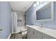 Stylishly renovated blue bathroom with gray tiling and a modern vanity at 515 Quinn Dr, Woodstock, GA 30188