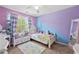 Bright bedroom featuring two-tone walls, a ceiling fan, and a cozy twin bed perfect for a  at 515 Quinn Dr, Woodstock, GA 30188