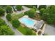 Aerial view of a refreshing community pool surrounded by lush trees and comfortable lounge chairs at 515 Quinn Dr, Woodstock, GA 30188