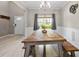 Bright dining area featuring modern decor, light floors, a large table, and a window at 515 Quinn Dr, Woodstock, GA 30188
