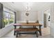 Bright dining area featuring modern decor, light floors, a large table, and a view to the kitchen at 515 Quinn Dr, Woodstock, GA 30188